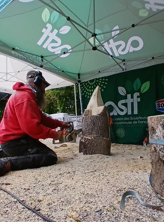 Sébastien Steffen, sculpteur à la tronçonneuse, en train de sculpter un nain à Lullin.