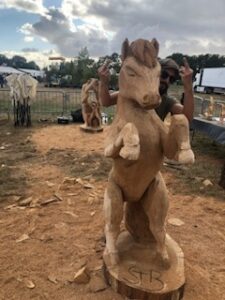 Sculpture sur bois d'un cheval cabré en plein air, réalisée à la tronçonneuse lors de la manifestation La petite Angevine.